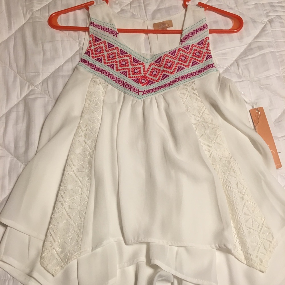 White top with multi color pattern along neckline